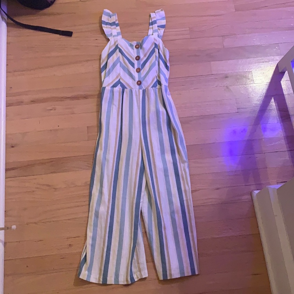 Jumpsuit with ruffles and buttons down the middle.